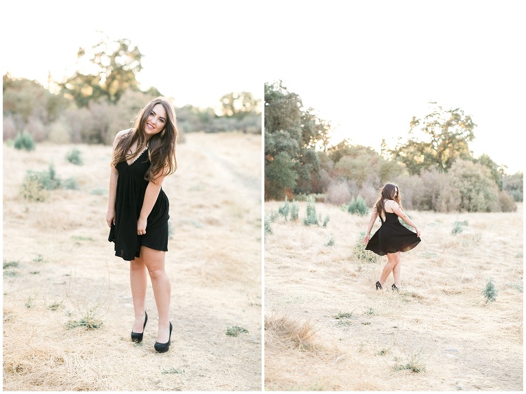 brunette in black dress dancing in a field