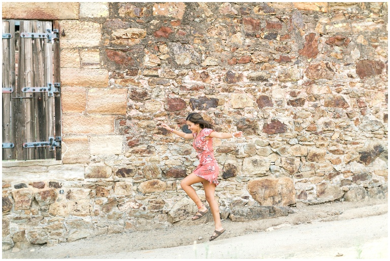girl in a pink dress skipping