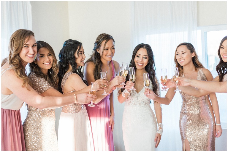 bridesmaids cheering with champagne glasses full, photo by jody Atkinson