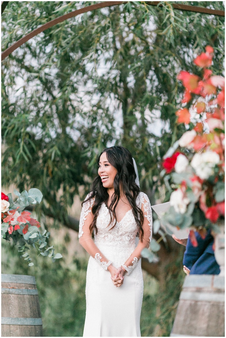 bride laughing during her sunset ceremony under the willow trees