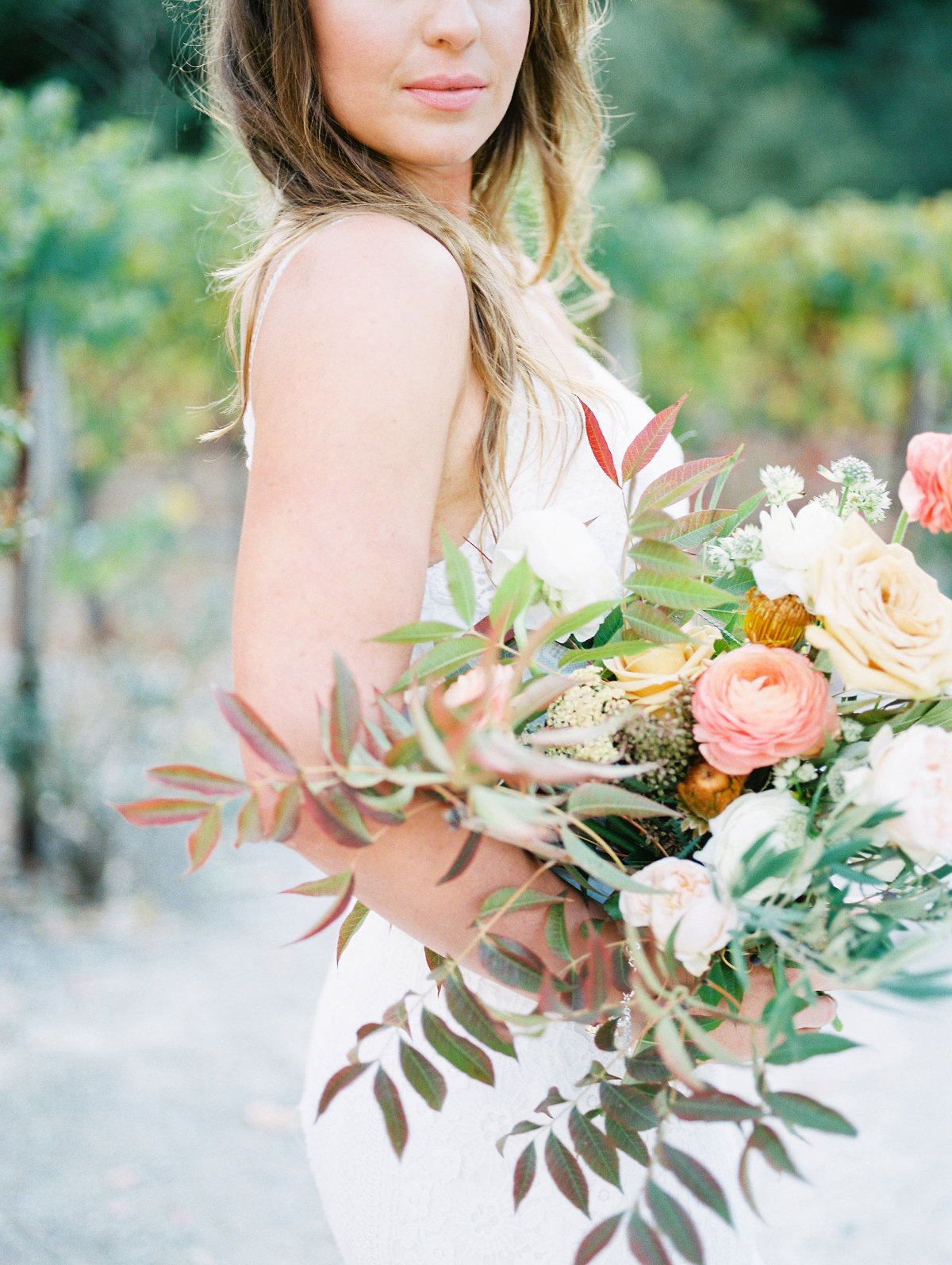 bride holding a bouquet with fall colors