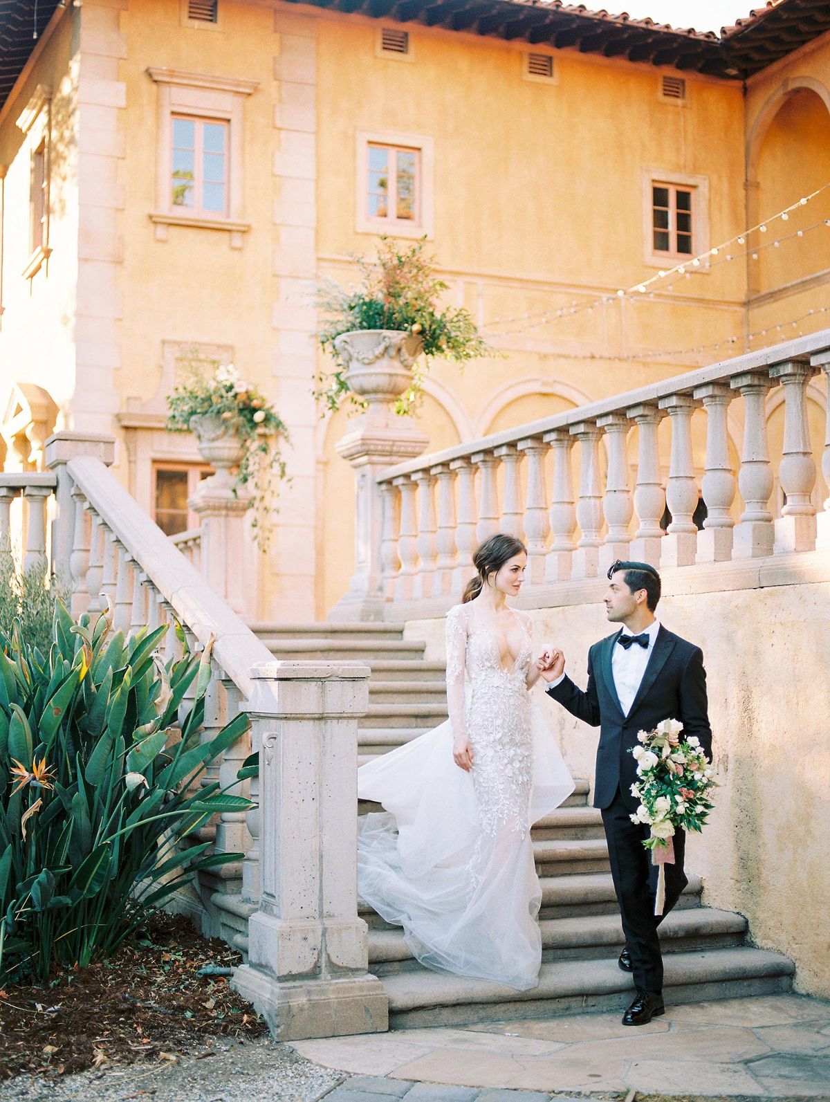 bride and groom walking down a stair case at an Italian villa