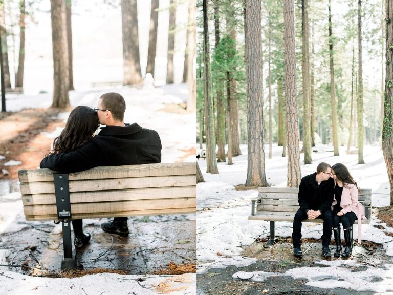 couple sitting on a park bench in the snow