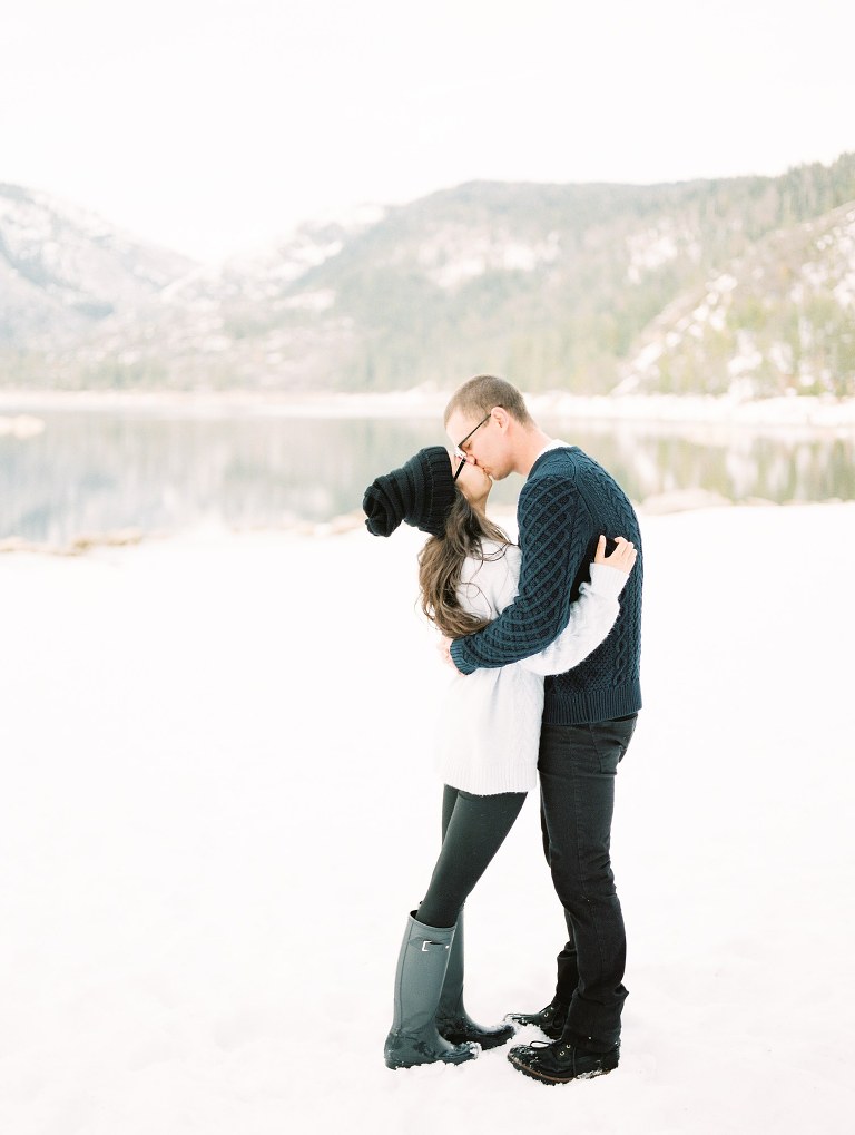 couple kissing on a snowy lake